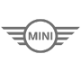 Logo der Automarke MINI mit charakteristischem Flügel-Design, das für sportliche Eleganz und kompakte Fahrzeuge steht. Ideal für Liebhaber von Stadtfahrzeugen und einzigartigem Design.